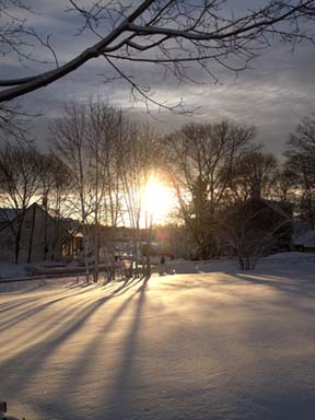 Snow-draped sunset on Sunday: Kenji Quinn snapped this shot from his home near River Street and Central Ave. in Lower Mills.